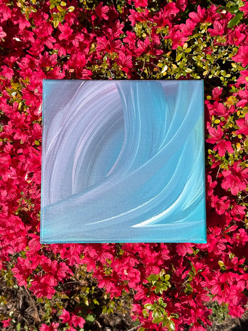 Abstract painting with wavy lines on a bed of pink flowers