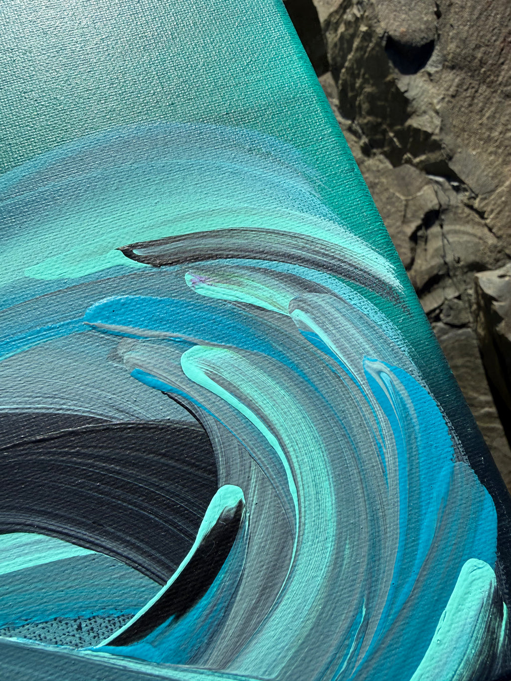 Abstract painting with swirling blue and green colors on a textured surface.