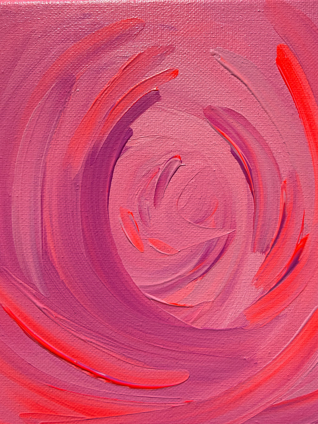 Abstract painting with swirling pink and red brushstrokes on a textured surface