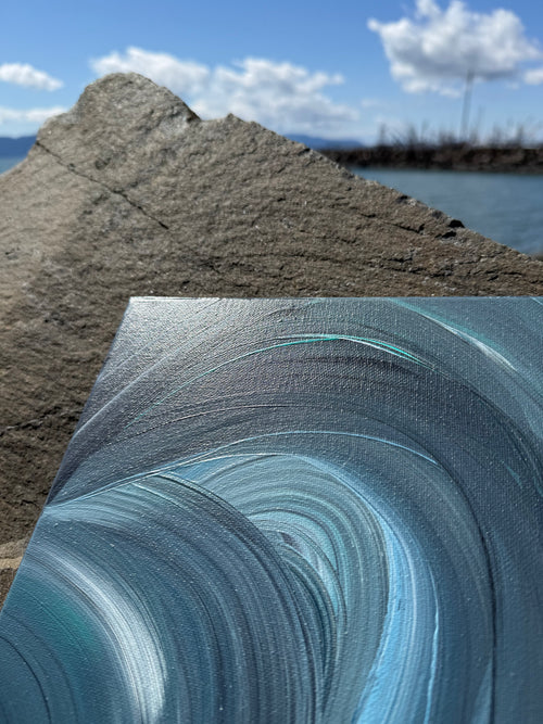Close-up of a textured blue surface with a beach and sky in the background