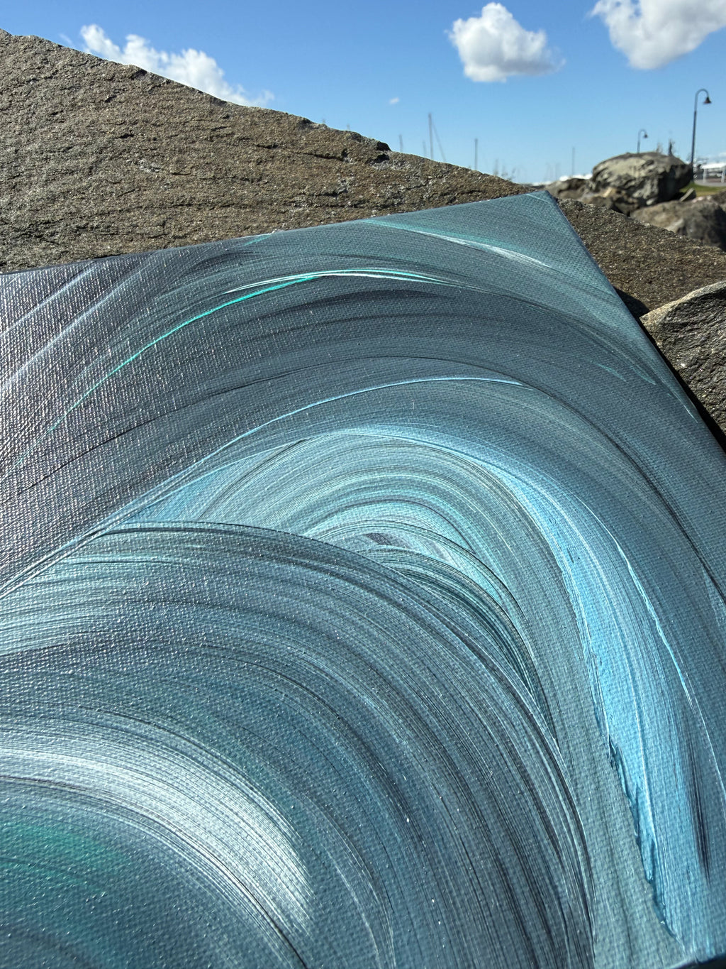 Close-up of a textured blue surface with a natural landscape in the background