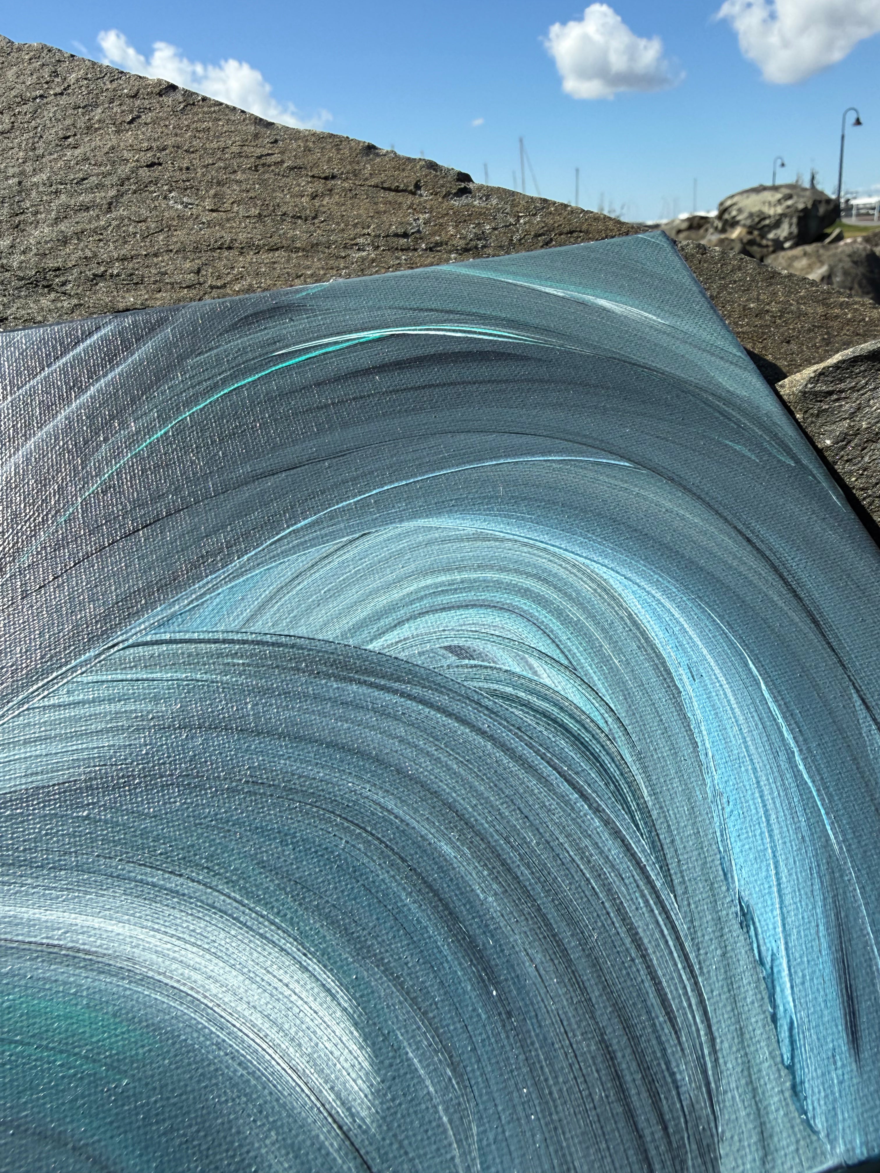 Close-up of a textured blue surface with a natural landscape in the background